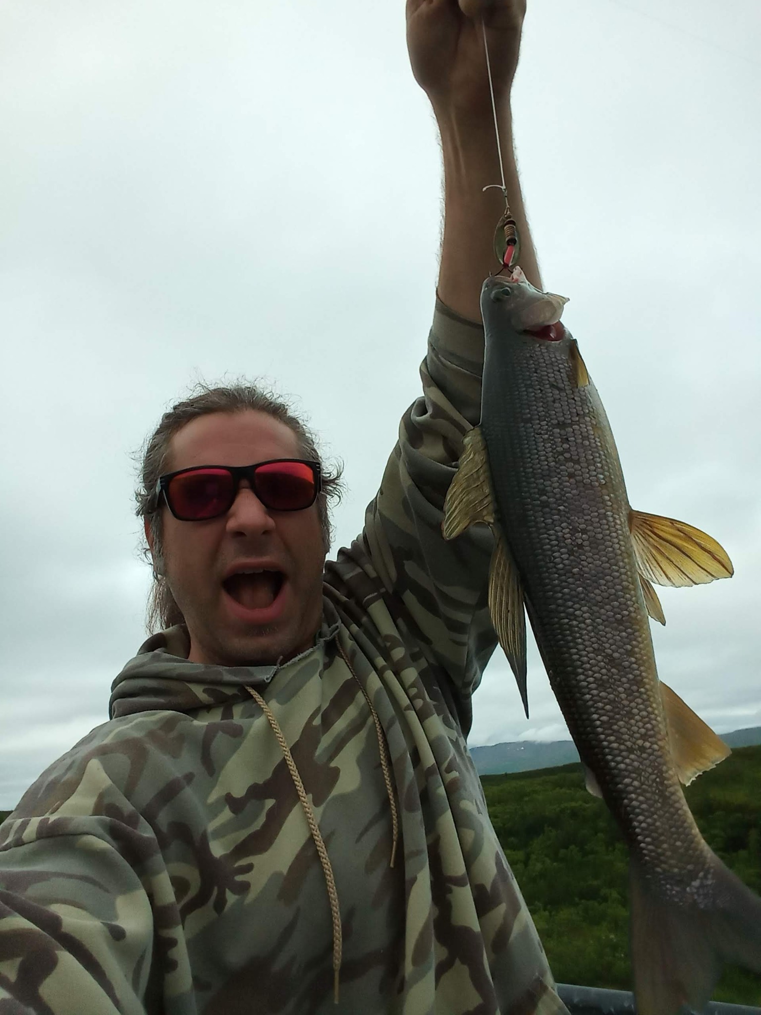 Russ holding an Alaska grayling