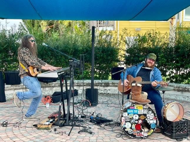 Russ performing outdoors with another musician